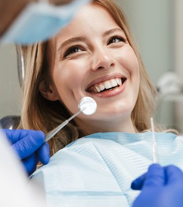 Lady smiles at dentist