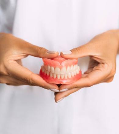 Lady presents dentures to viewer