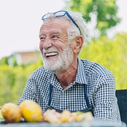 Man smiles over corn on the cob