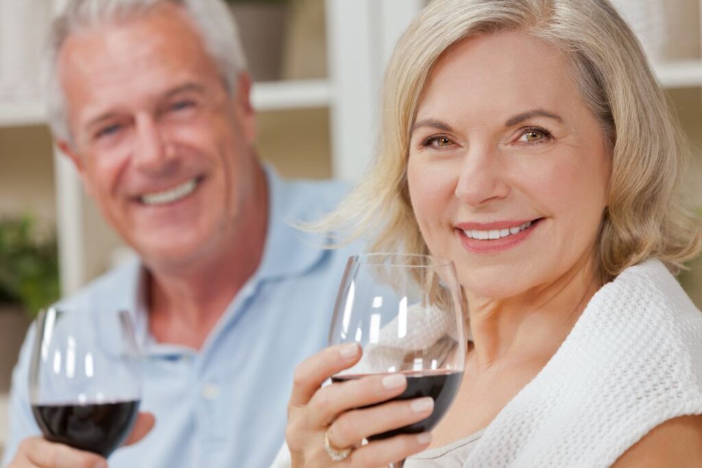 A man and woman drinking red wine.